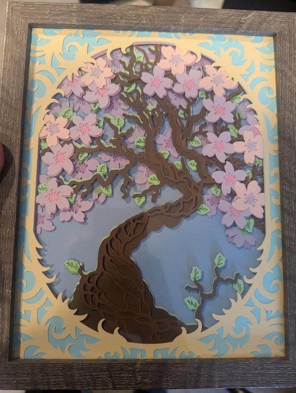 Layered paper artwork by Card and Canvas